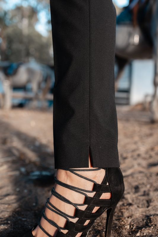 Détails du pantalon rose orné avec fond blanc, une option chic.