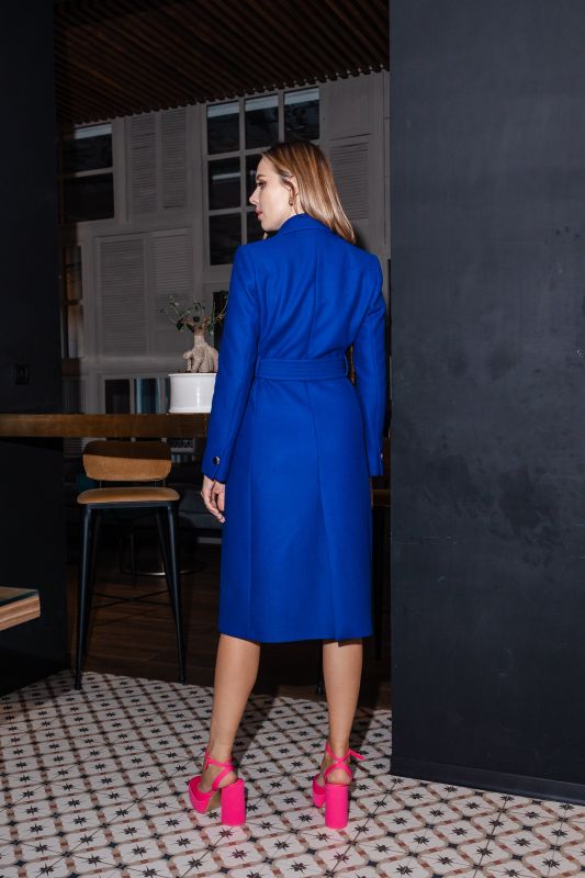 Manteau bleu avec ceinture de la même couleur, pour un look coordonné.