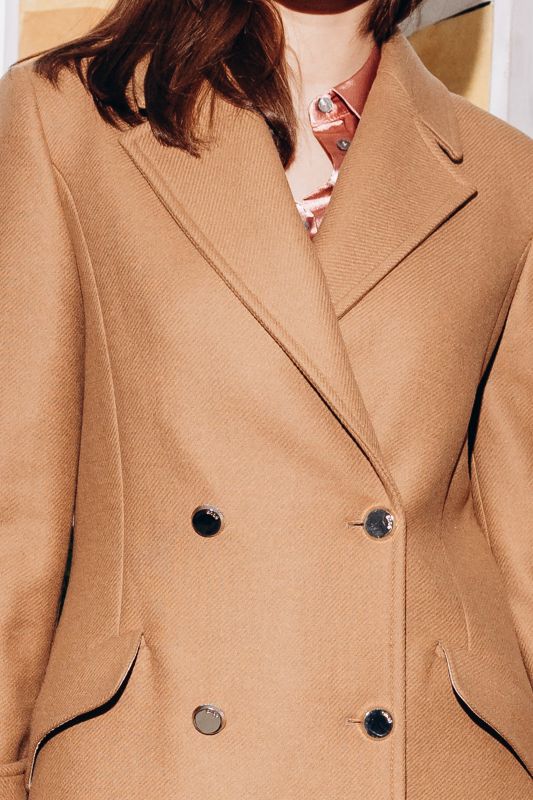 Détails du manteau beige classique, une élégance sobre.
