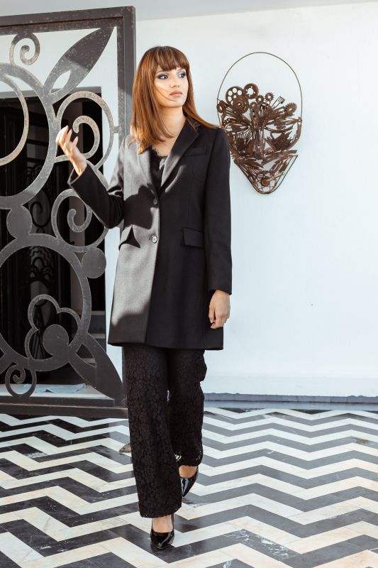 Un manteau noir élégant avec deux boutons.