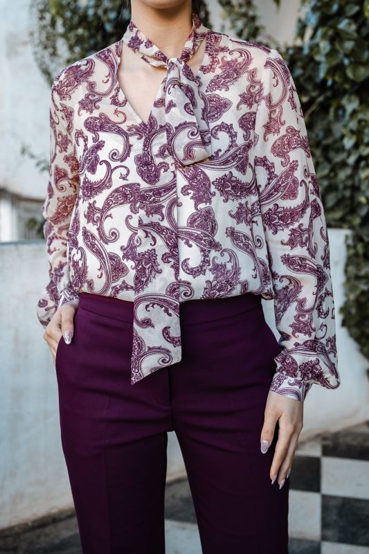 Blouse ornée de fleurs violet foncé sur fond blanc
