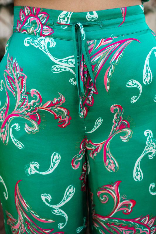 Détails en gros plan du pantalon vert imprimé orné pour femmes.