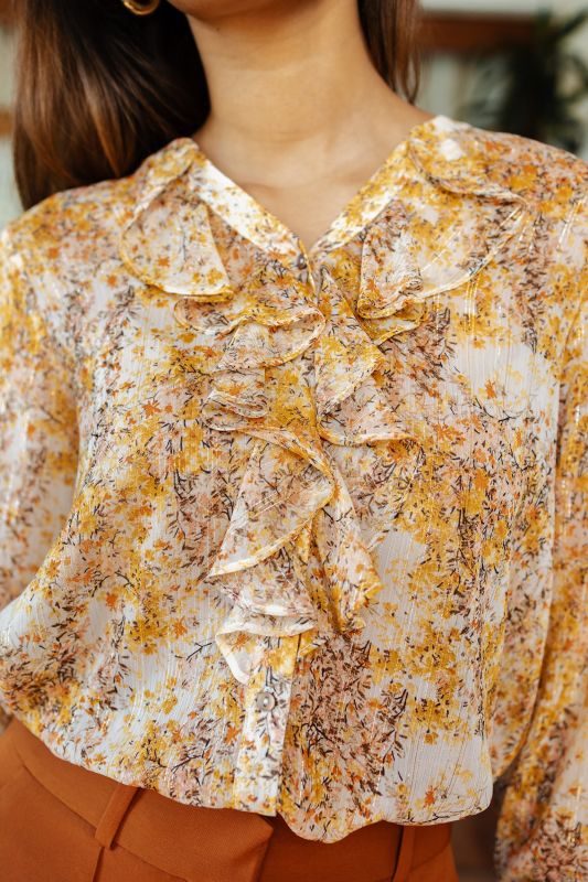 Gros plan sur le motif détaillé de la blouse imprimée, reflétant un style unique.