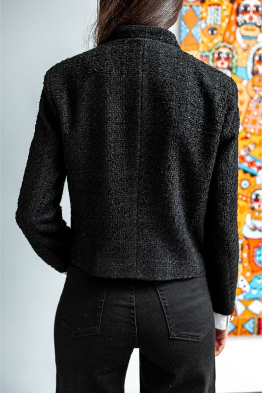 La veste en tweed noir ALYANA de la collection TWEED 24 d'ANAE, associant tradition et modernité pour un style affirmé.