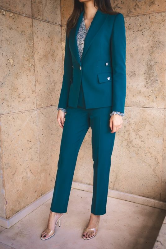 Tenue de tailleur ANAE bleu émeraude avec blazer structuré et pantalon fuselé, incarnant l'élégance moderne.